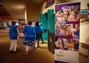 image of welcome sign and people walking into room