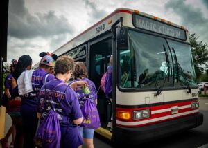 people loading buses for disney world