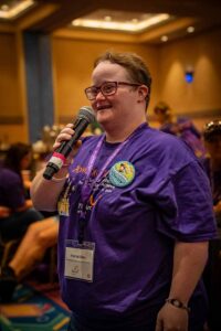 lady in purple shirt with microphone