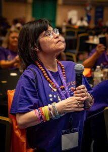 lady in purple shirt with microphone