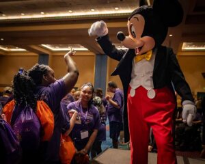 image of mickey mouse waving to crowd of people