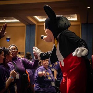 image of mickey mouse waving to crowd of people