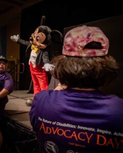 image of mickey mouse waving to crowd of people