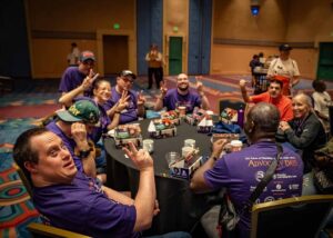 people smiling in matching purple shirts