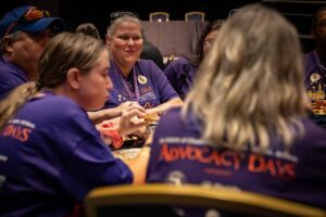 people smiling in matching purple shirts